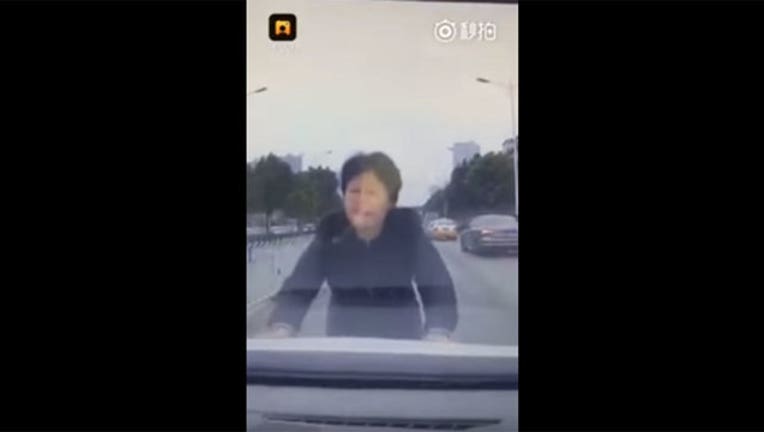 Woman in China Pretends to be Struck by Vehicle-402970
