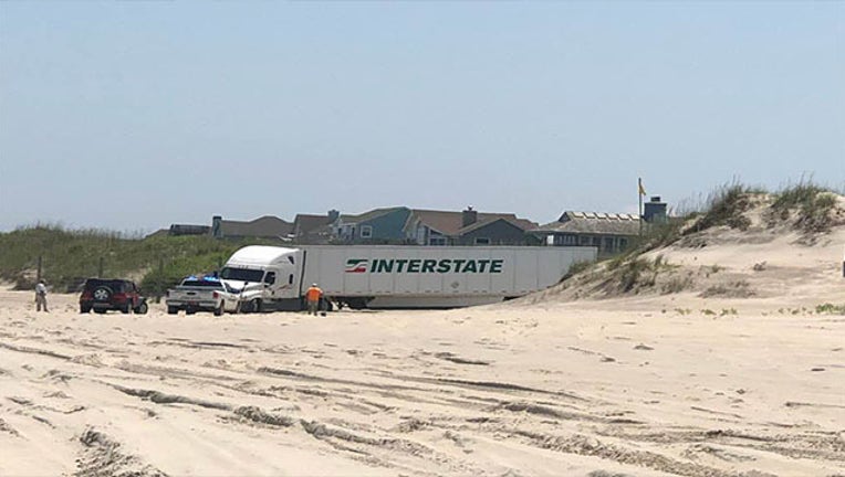 e1eabccc-tractor trailer caught in sand Kim Hoey_1530653677073.jpg-403440.jpg