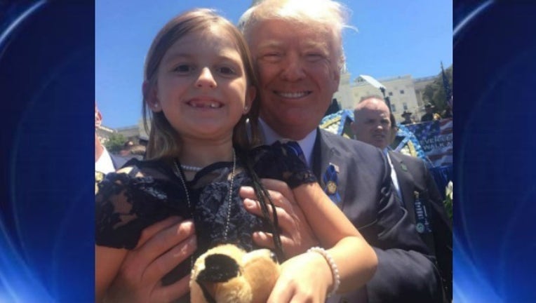 37a38660-trump and little girl_1494881652361.jpg