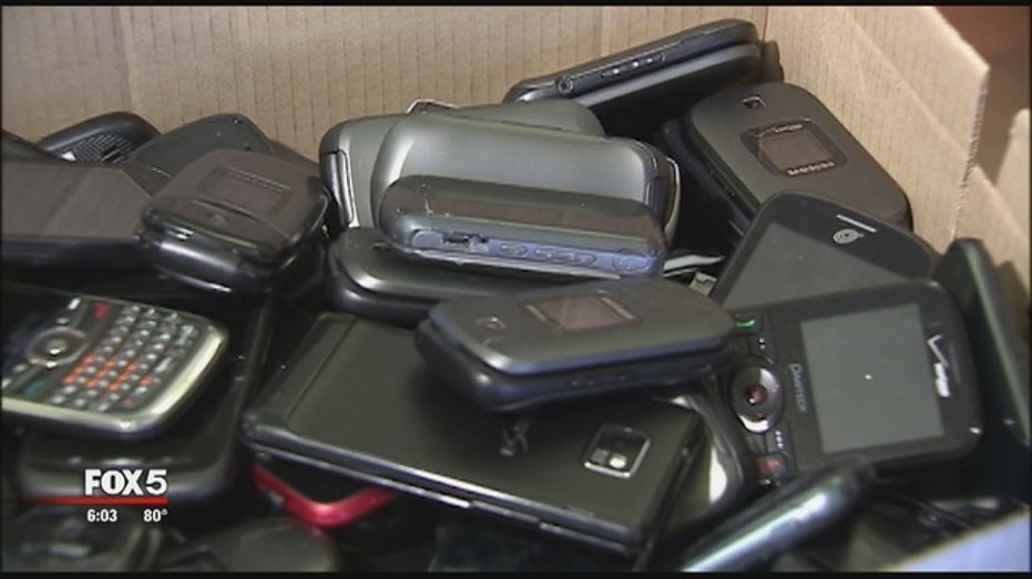 Students using cell phones in school hallway