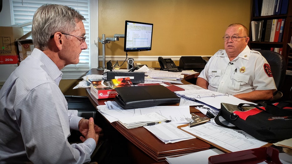 Randy sitting with deputy chief behind his desk