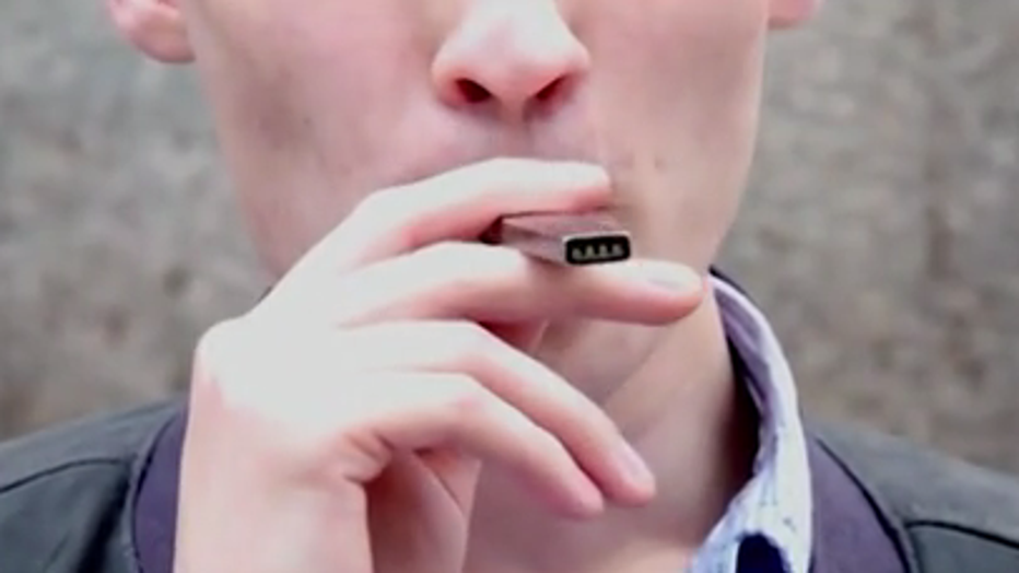 Man uses vaping or e-cigarette device