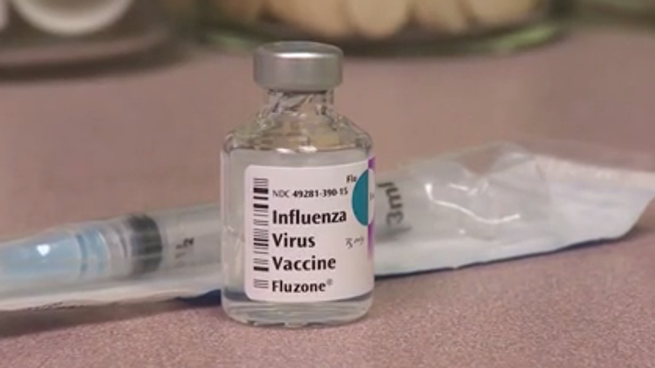 A vial of flu vaccine sits on a counter at a health provider's office