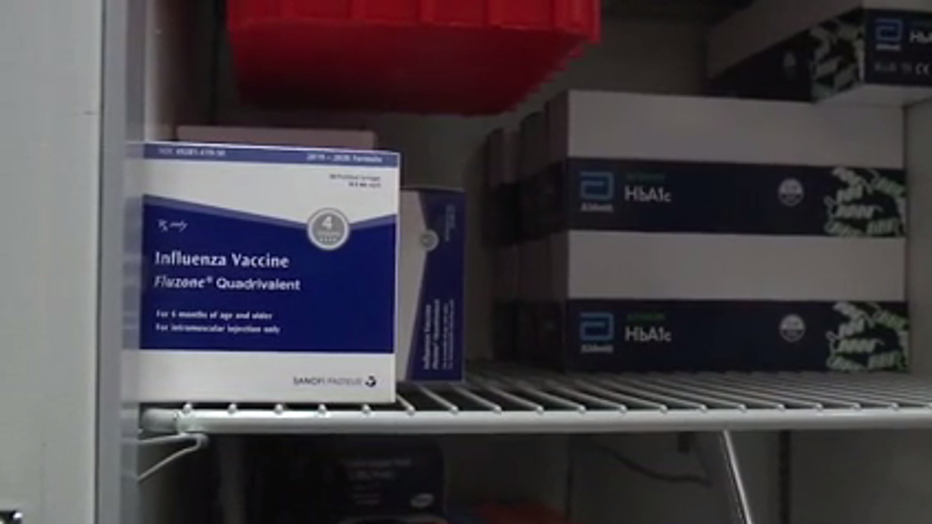 A box of flu vaccine sits in a freezer.