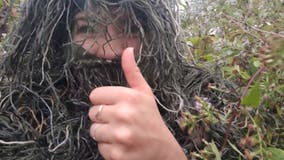 Woman disguises herself as bush to photograph sister's engagement