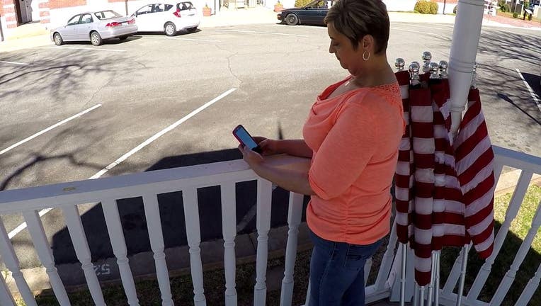 woman sitting in gazebo look at her phone