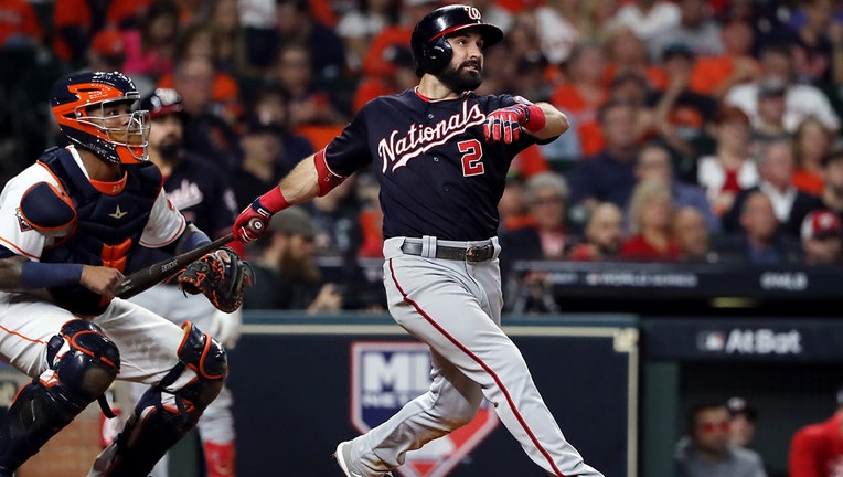 HOUSTON, TEXAS - OCTOBER 23: Adam Eaton #2 of the Washington Nationals hits his two-run home run against the Houston Astros during the eighth inning in Game Two of the 2019 World Series at Minute Maid Park on October 23, 2019 in Houston, Texas. (Photo by Elsa/Getty Images)