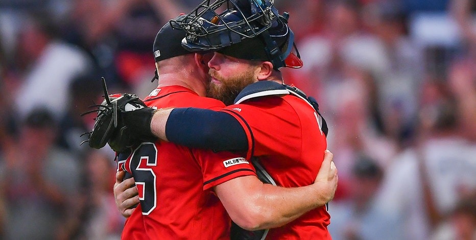 Braves catcher Brian McCann enjoys family time with his 1-year old