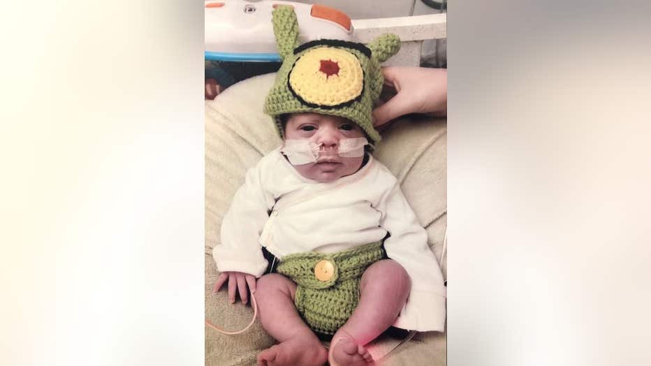 Baby wears Halloween costume.