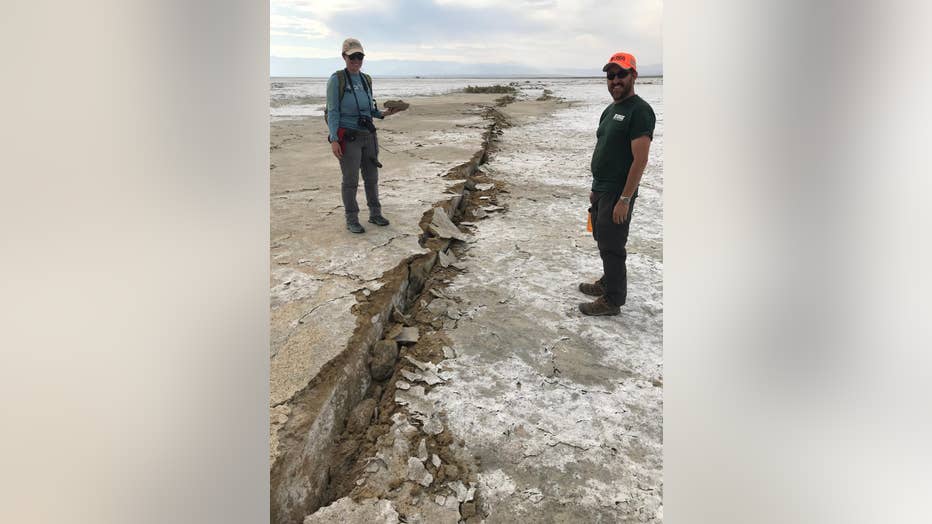 USGS-geologist-Josie-Nevitt-and-geodesist-Todd-Ericksen-collect-a-sample-from-the-fault-zone-of-the-main-rupture___Ben-Brooks-USGS..jpg