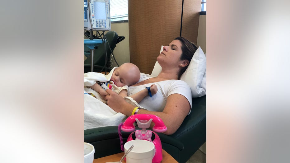 Mother and daughter sleep during a chemotherapy infusion