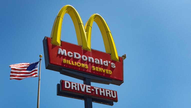 The sign for McDonald's drive in take-away restaurant and an American flag in the Silver Lake area of Los Angeles. (Photo by Epics/Getty Images)