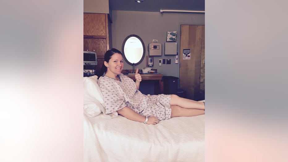 Ashley Gunter sits on a hospital bed during her treatment.