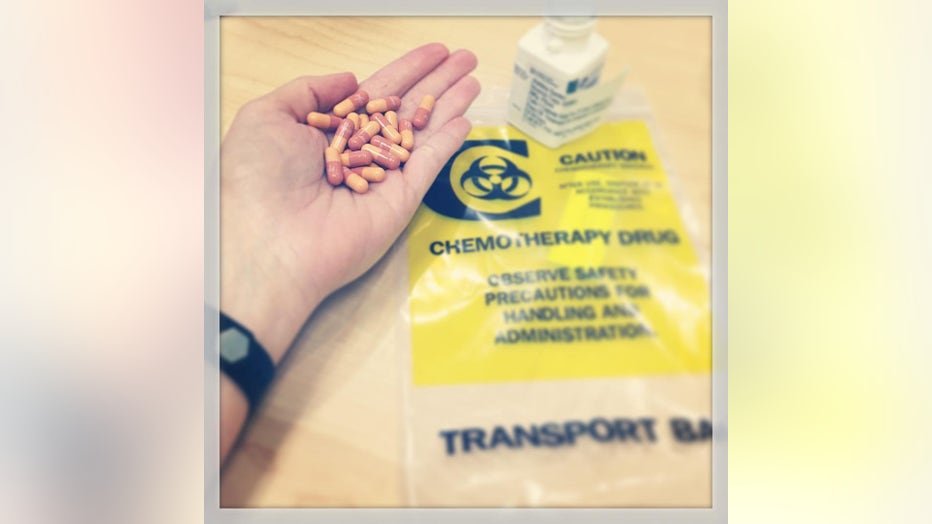 Ashley Gunter holds a handful of chemotherapy pills.