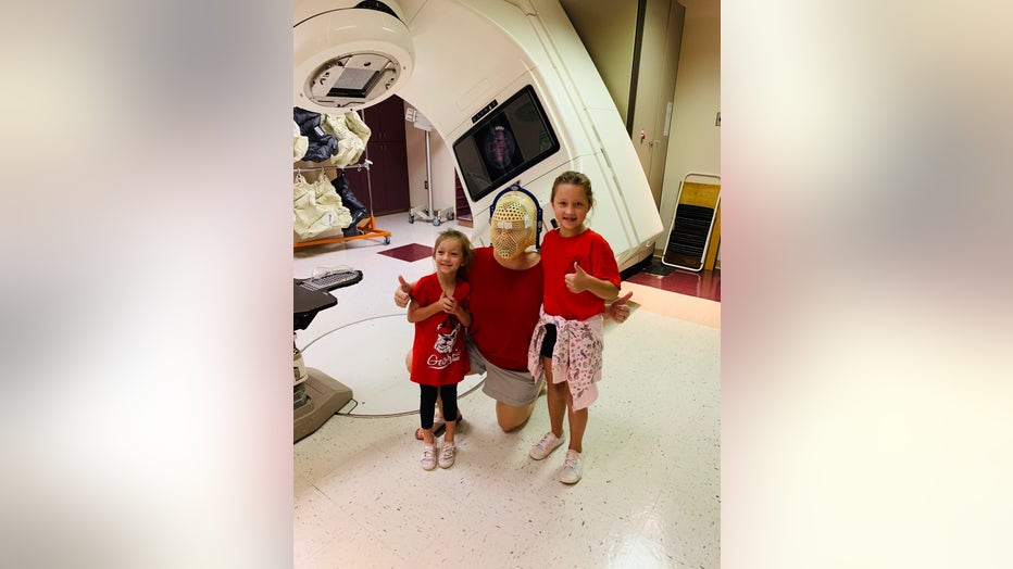 Ashley Gunter wears radiation mask after her treatment.