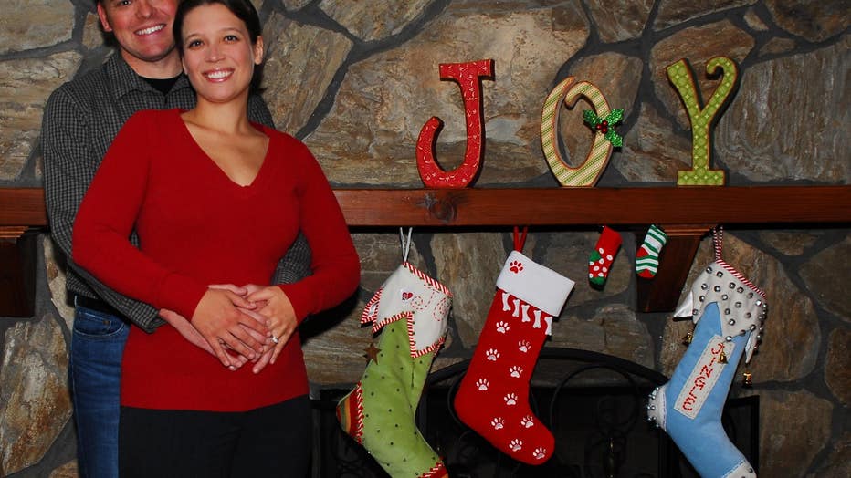 Couple poses at fireplace