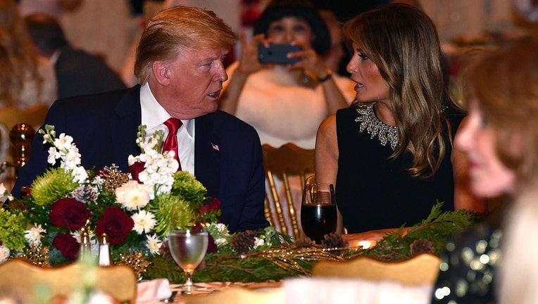 US President Donald Trump and First Lady Melania Trump attend a Christmas Eve dinner with his family at Mar-A-Lago in Palm Beach, Florida on December 24, 2019.