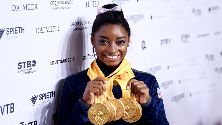 STUTTGART, GERMANY - OCTOBER 13: Simone Biles of The United States poses for photos with her multiple gold medals during day 10 of the 49th FIG Artistic Gymnastics World Championships at Hanns-Martin-Schleyer-Halle on October 13, 2019 in Stuttgart, Germany. (Photo by Laurence Griffiths/Getty Images)