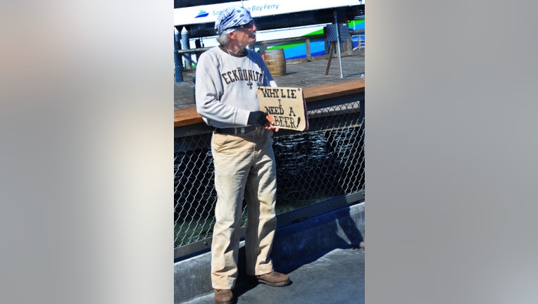 SAN FRANCISCO, CA - MAY 16, 2013: A 'panhandler' with a sense of humor solicits handouts at San Francisco's Fisherman's Wharf district, a popular shopping, entertainment and restaurant complex. (Photo by Robert Alexander/Archive Photos/Getty Images)