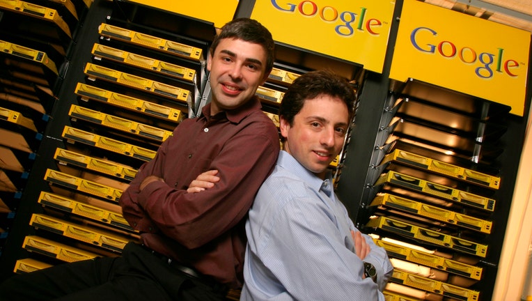 FILE - Larry Page (L), Co-Founder and President, Products and Sergey Brin, Co-Founder and President, Technology pose inside the server room at Google's campus headquarters in Mountain View. They founded the company in 1998.
