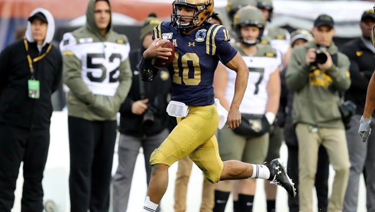 Malcolm Perry #10 of the Navy Midshipmen scores a touchdown in second quarter against the Army Black Knights at Lincoln Financial Field on December 14, 2019 in Philadelphia, Pennsylvania.