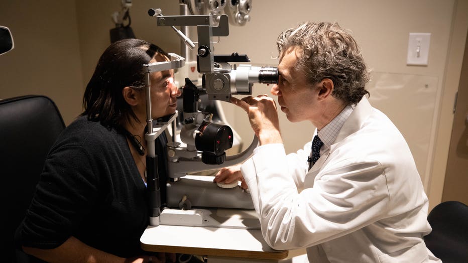 Eye surgeon checks woman's vision