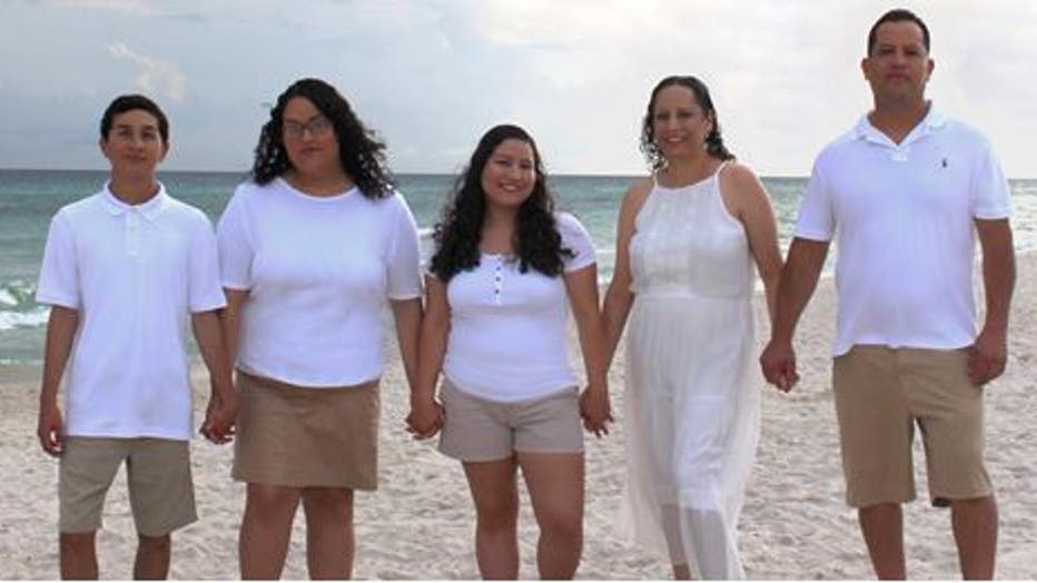 Hernandez family stands on beach
