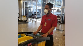 Workers, airport travelers don masks out of concerns about deadly coronavirus