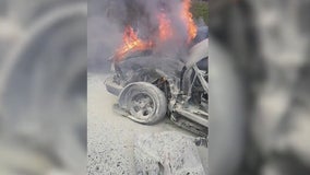 Strangers rescue woman trapped in burning car on I-85