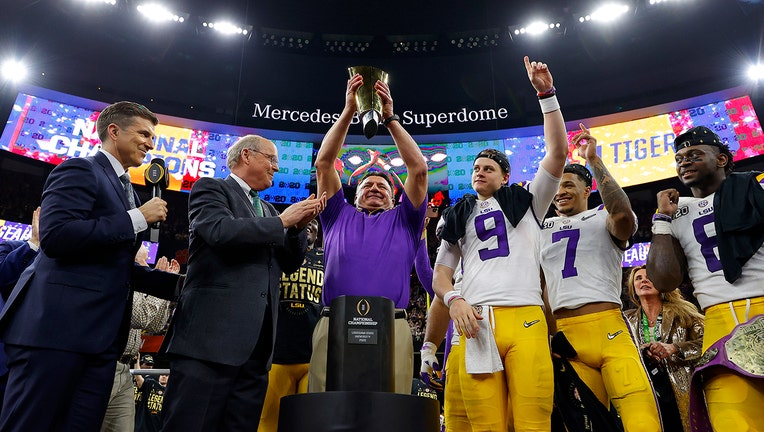 NEW ORLEANS, LOUISIANA - JANUARY 13: Joe Burrow #9 of the LSU Tigers celebrates with head coach Ed Orgeron of the LSU Tigers after defeating the Clemson Tigers 42-25 in the College Football Playoff National Championship game at Mercedes Benz Superdome on January 13, 2020 in New Orleans, Louisiana. (Photo by Kevin C. Cox/Getty Images)