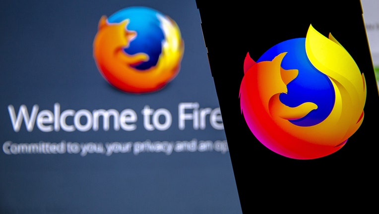 Mozilla Firefox logos are seen displayed on a laptop and phone screen. (Photo by Ali Balikci/Anadolu Agency/Getty Images)