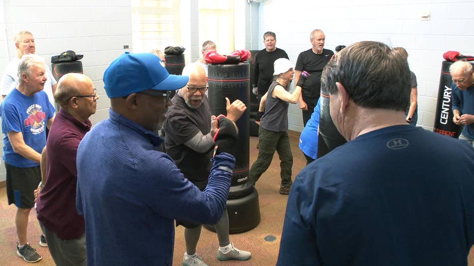 Room filled with people boxing.