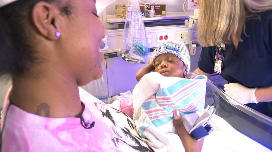 Mom holds baby in NICU