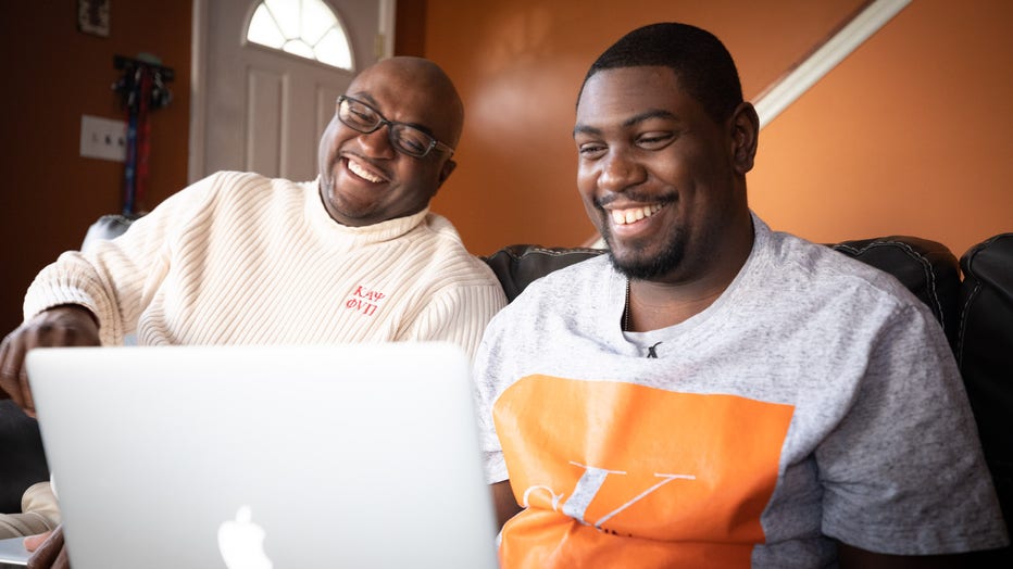 Two men laugh together