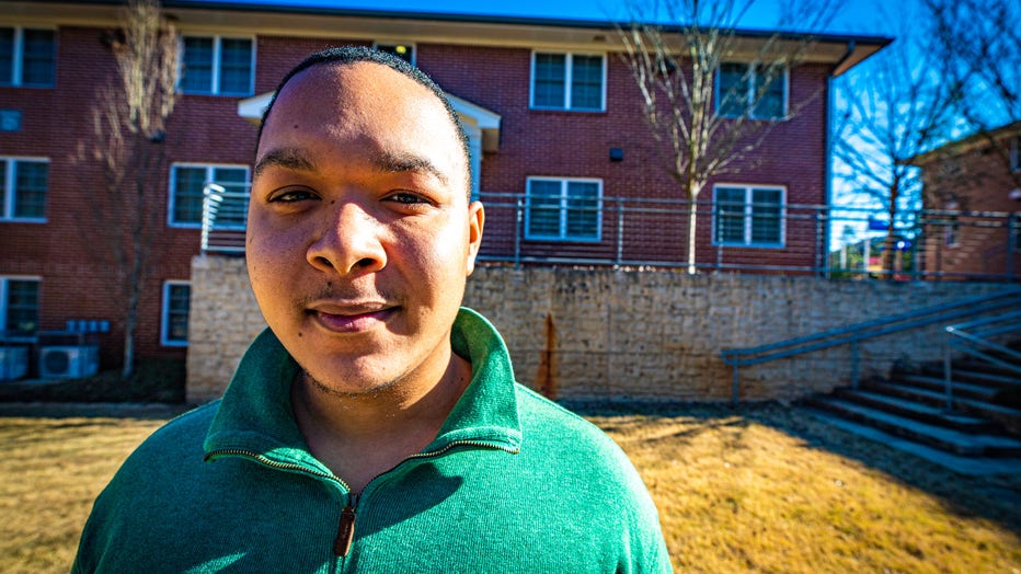 Man stands outside home