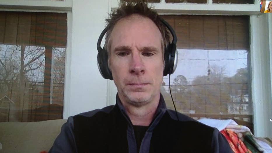 Man wearing headphones talks to reporer via Skype.