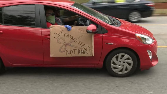 Protesters drive by Governor's mansion to show disapproval of Governor Kemp's decision to reopen businesses