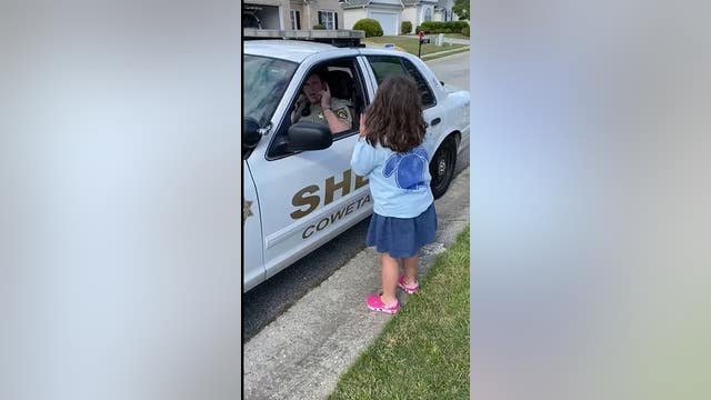 Coweta County deputy shares a sweet moment with his daughter through sign language