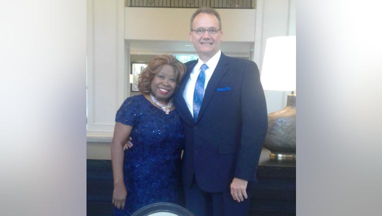woman and man pose for photograph in party clothes