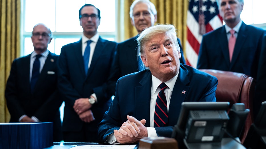193ece0b-President Trump Signs Coronavirus Stimulus Bill In The Oval Office