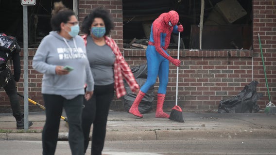 Volunteers clean up trash, graffiti and debris following Twin Cities protests