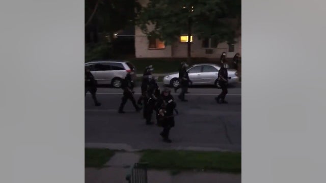 Video: Law enforcement fires paint projectile at residents on porch during curfew in Minneapolis