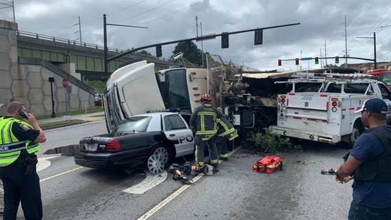 Police: Semi-truck flips over onto Smyrna police patrol car, trapping officer