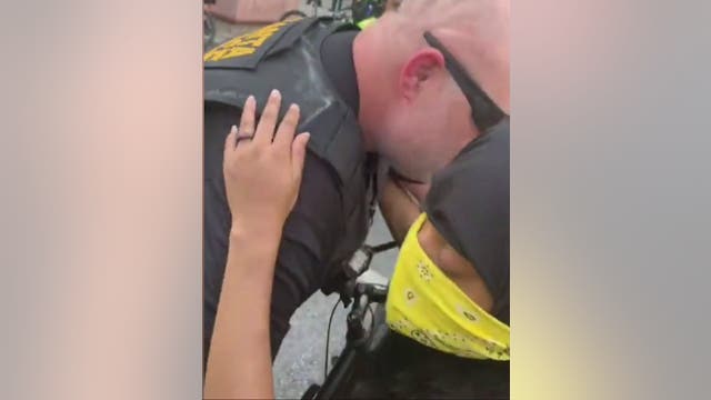'I promise you. I love you.' An officer and protester connect during demonstration