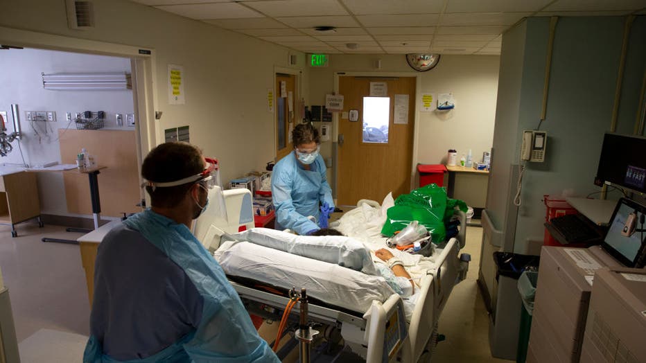 7f0d3163-Health Care Professionals Treat Coronavirus Patients On The Acute Care Floor Of Harborview Medical Center