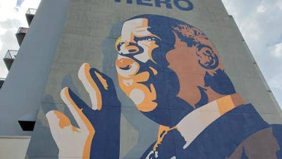 Mourners gather at the John Lewis mural to pay their respects