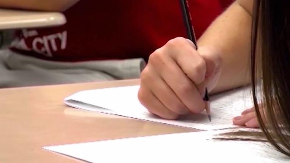 Child writes on paper