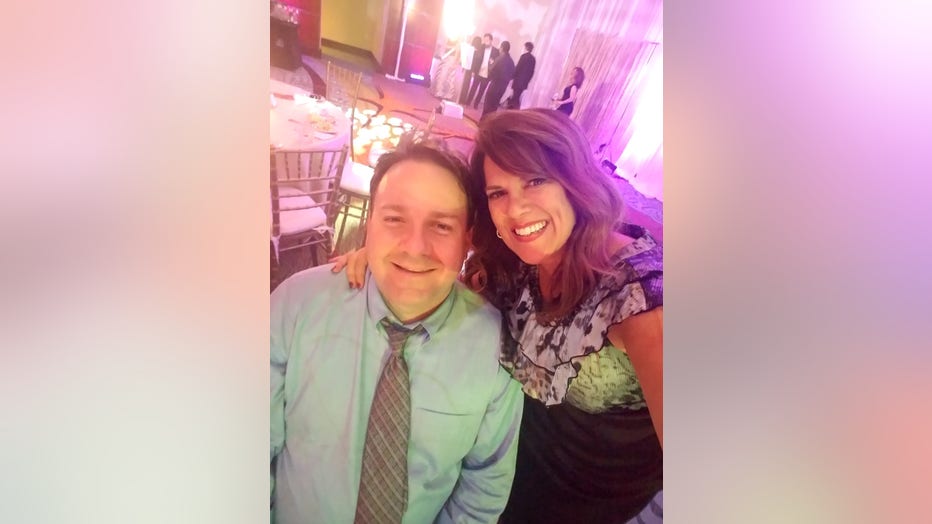 Woman smiles and hugs husband at a party
