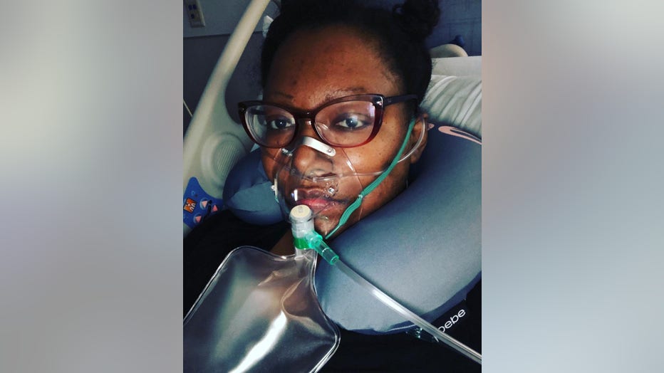 Woman in ICU wears oxygen mask and nose canula