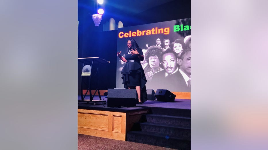 Woman speaks on stage at event